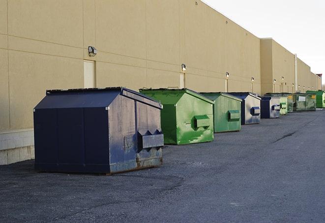 a row of industrial dumpsters at a construction site in Avoca